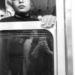 black and white photo of a subway train conductor looking out the window
