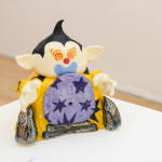 Christopher Gale's sculpture of goblin figure with a yellow jacket and black stars