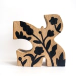 ceramic piece by Jocelyn Tsaih of a brown figure with black flowers on it