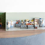 miniature diorama by Abigail Goldman of a restaurant with a human body being prepared in the kitchen s