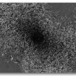 Still from video showing a black hole on a gray background