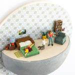 miniature diorama by Abigail Goldman of a naked woman bleeding out on a bed next to a man begging on his knees and another woman with a gun