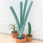Jeff Canham wooden plant sculptures in terra cotta pots- in a cluster on the floor