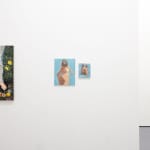 white gallery wall with paintings of various sizes