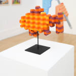 photo of a wooden sculpture in the shape of a goldfish by Casey Gray