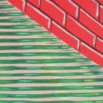 Detail; the bottom of the red brick pyramid meets the green and beige ground.