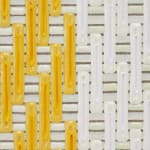 Detail; dark and light yellow, white, and dark green columns painted over horizontal white and beige stripes.