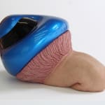 Three-layered sculpture in snail shape. Top layer is a mushroom-shaped motorcycle helmet with shiny blue paint and dark fiberglass. Middle layer is like a stomach lining connected to the last layer, which is an upper thigh and knee with human skin and hair.