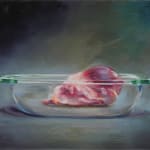 Large animal heart sits in clear glass cooking dish.