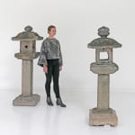 Woman standing with two stone lanterns.
