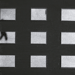 Gif of a spread out grid of nine rectangular pieces with white LEDs behind Plexiglass. The LEDs display black and white scenes of shadowy figures walking around Grand Central Terminal in New York City