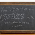 An image of a wooden chalkboard sign.