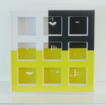 Back view of the box. Cut-outs visible on the yellow and black background.