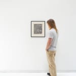 A white man admires UNTITLED FEBRUARY 28, 1967 while it is installed
