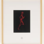 Wooden frame with white mat and black rectangle depicting red running woman.