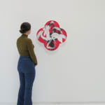 Wide installation view of Birth-Death-Rebirth with woman to the left of the piece to show scale
