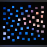 An image of little random square pegs in a black panel of exploded random colors