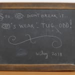 An image of a wooden chalkboard sign.