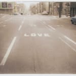 Enlarged print of an original photograph of a performance piece The photo captures the urban nineteen fifties landscape scene of the word LOVE painted in white onto San Francisco’s Oak Street