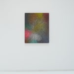 A multicolored, brightly colored abstract painting hangs on a white wall.