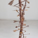 Two old christmas trees with few bare branches which have been turned into arrows with household and found items such as seeds, dried leaves, food scraps, and twine. The sculpture referencing the popular Italian Renaissance and Christian subject of Saint Sebastian who was often depicted with multiple arrows shot through his body