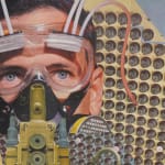 Detail: A man wearing clear goggles and a gas mask made of circuit boards stares upwards.