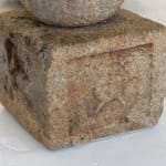Square base of small stone sculpture.