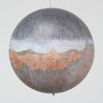 Hanging sphere covered with a drawing of a red rock mountainous landscape and a starry skyscape with a milky white band.