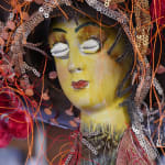 A detailed shot of the doll's face and hat on the doll.