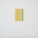 A yellow, white, green and grey abstract painting mimicking fabric hangs on a white wall.