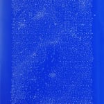 Millions of minuscule white dots make a vertical rectangle on a bright blue background.