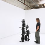 Installation view of Totem with a white man admiring it