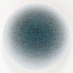 Front view of a blue ombre circle created from overlapping threads.