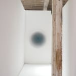 Hallway view of a blue ombre circle, fading from dark blue to white from the center.