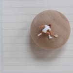 Close up of the tennis player figurine on the surface of the wooden sphere in Tennis Player