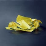 One crumpled yellow Post-it note with blue writing against dark gray background.