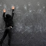 Video of ​​Driss Ouadahi creating Oppressed Blessing The artist is dressed in all black with white chalk on his hands jumping to create handprints on large black canvas