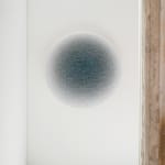 Closer hallway view of a blue ombre circle, fading from dark blue to white from the center.