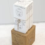 An image of boxes stacked up with drawings all over.
