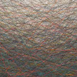 Detail of edge depicting dark multicolored threads.