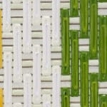 Detail; light yellow, white, dark and light green columns painted over horizontal white and beige stripes.