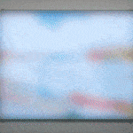 Gif of rectangular piece with multiple multi-colored LEDs behind Plexiglass that displays a blurred and abstract scene of prayer flags flapping in the wind