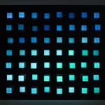 An image of little square pegs in a black panel of exploded random colors