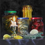 Still life of lit candle, two lemon slices, four jars of preserved vegetables and a mandolin slicer with round white vegetable.