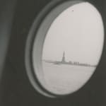 Ilse Bing photograph of the Statue of Liberty through a round window