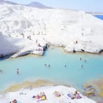 Sarakiniko Beach on Milos Island, Greece with swimmers and sunbathers, by Massimo Vitali