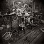Virginia and Jessie blowing bubbles on outdoor porch, from the Immediate Family series, by Sally Mann