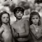 Emmett, Jessie and Virginia posing outdoors, from the Immediate Family series, by Sally Mann
