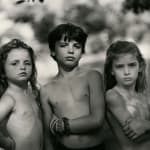 Emmett, Jessie and Virginia posing outdoors, from the Immediate Family series, by Sally Mann