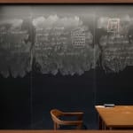 Wall sized chalkboard with erasures and formulas by professor Noga Alon, with wooden chair and desk in front, from the Do Not Erase series by Jessica Wynne